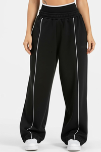 Women's black-bottomed casual pants with white stripes.