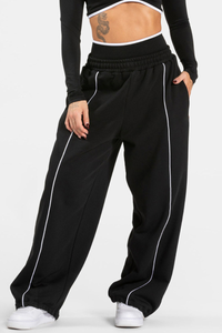 Women's black-bottomed casual pants with white stripes.