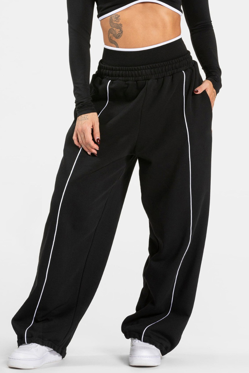Women's black-bottomed casual pants with white stripes.