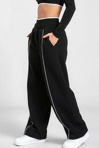 Women's black-bottomed casual pants with white stripes.