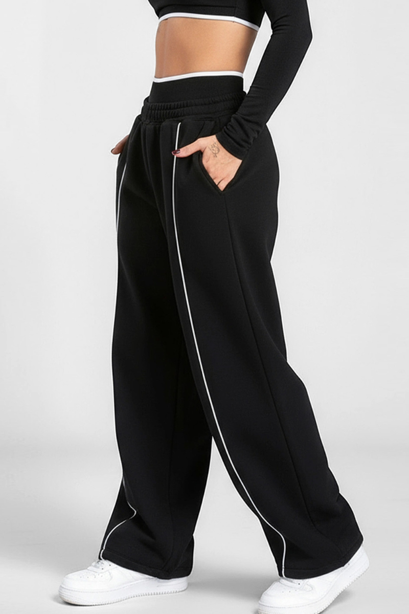 Women's black-bottomed casual pants with white stripes.