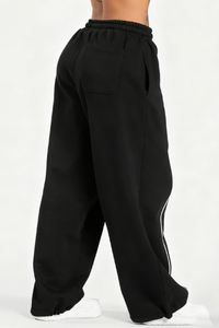 Women's black-bottomed casual pants with white stripes.