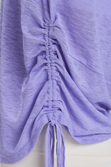 Women's side-seamed drawstring waist long-sleeved shirt.